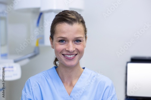 Portrait of dental assistant standing in dental clinic