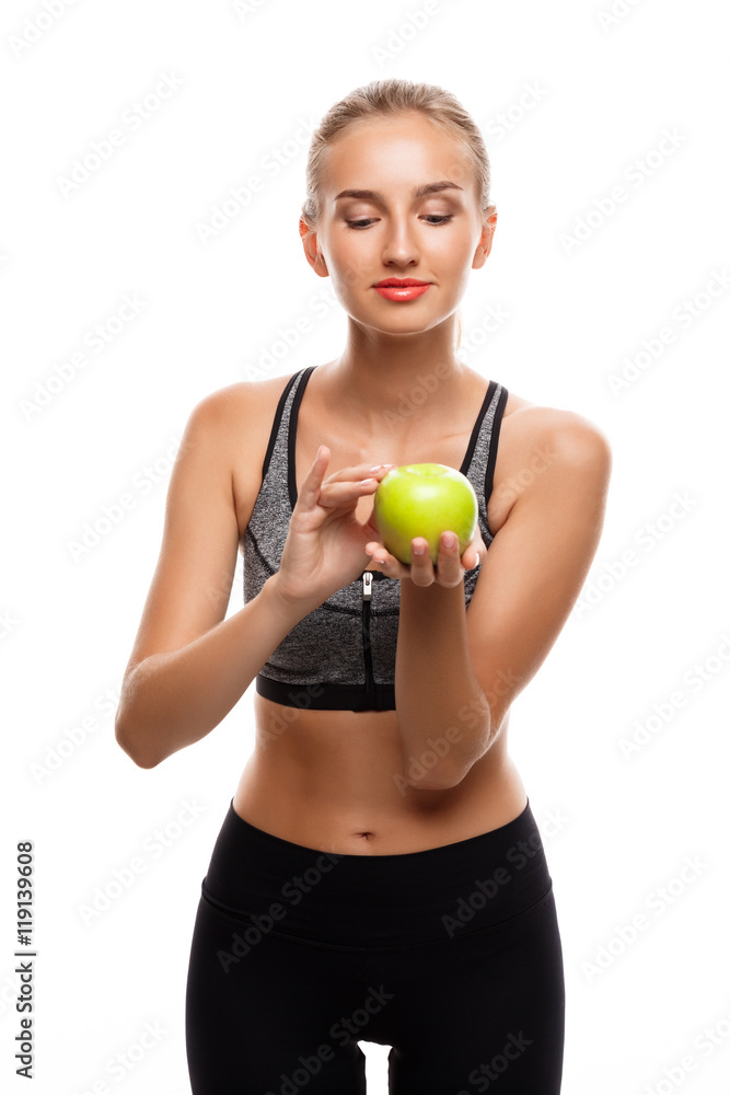 Beautiful sportive girl posing, holding apple over white background. Beautiful sportive girl posing, holding apple over white background.