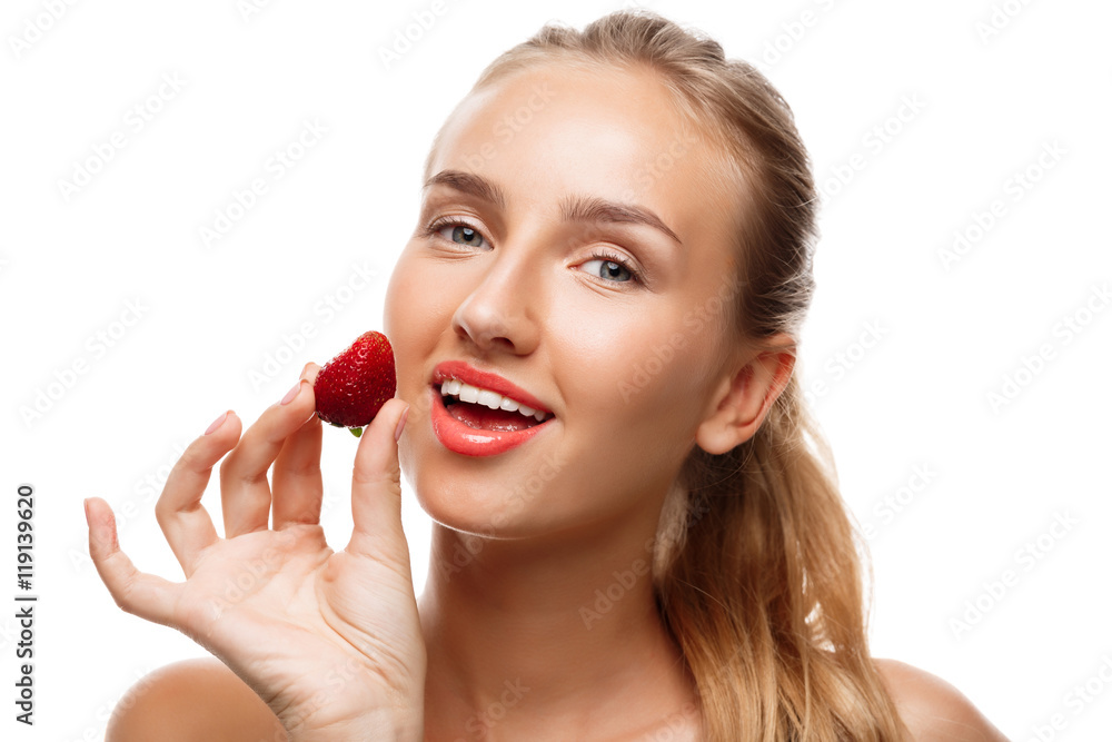 Beautiful sportive girl posing, eating strawberry over white background. Beautiful sportive girl posing, eating strawberry over white background.