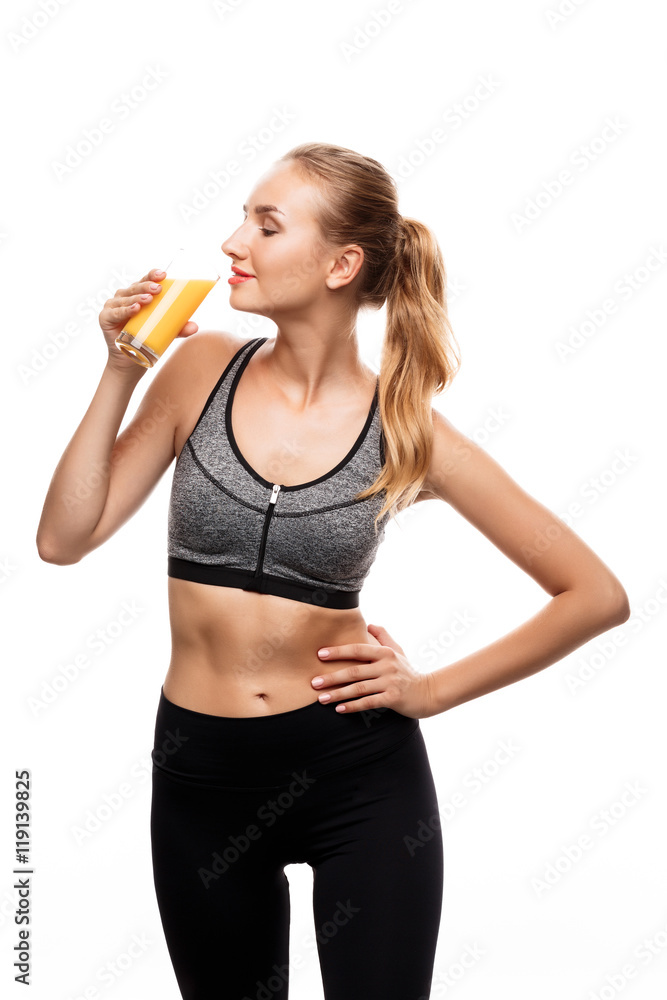Beautiful sportive girl holding glass with juice over white background. Beautiful sportive girl holding glass with juice over white background.