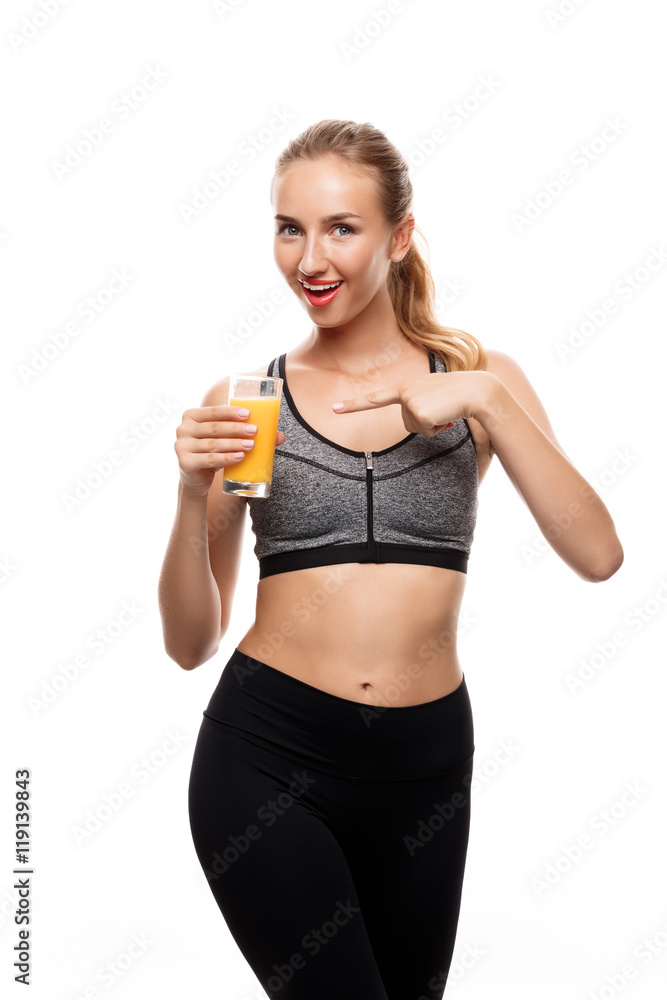 Beautiful sportive girl holding glass with juice over white background. Beautiful sportive girl holding glass with juice over white background.