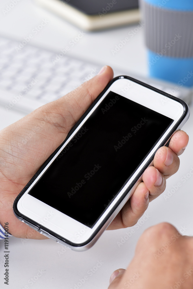 man at his office with a blank smartphone man at his office with a blank smartphone