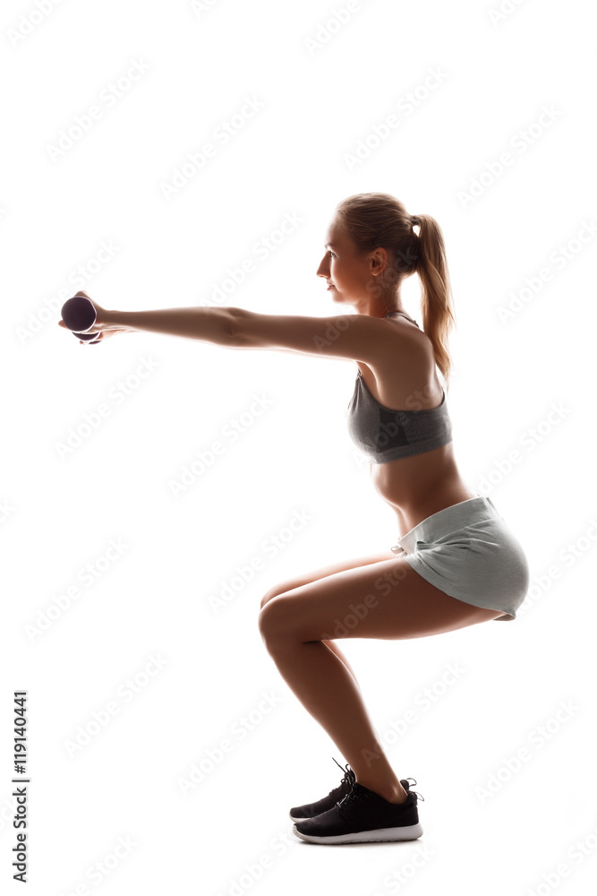 Beautiful sportive girl training with dumbbells over white background. Beautiful sportive girl training with dumbbells over white background.