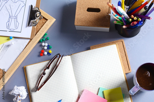 Desk of an artist with lots stationery objects. Studio shot on wooden background