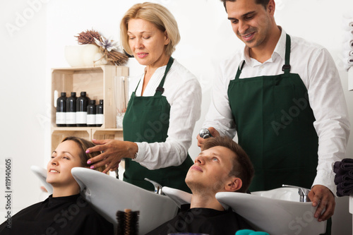 Hairstylists washing the hair of customers photo