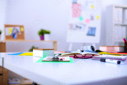 Desk of an artist with lots  stationery objects. Studio shot on wooden background