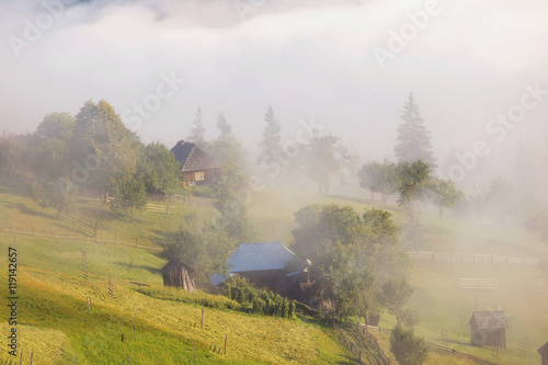 Beautiful foggy morning in the romanian village, in Bucovina