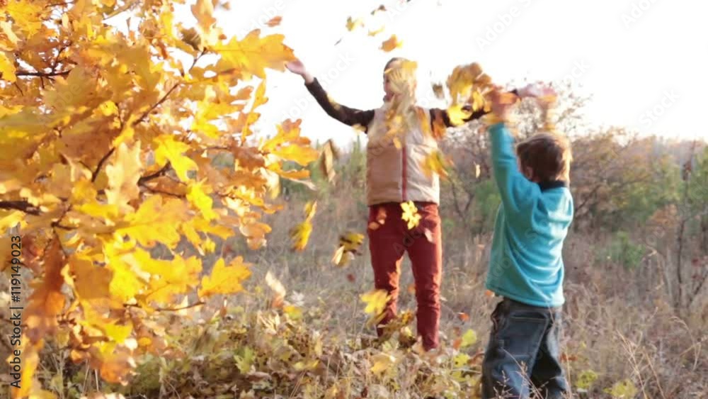 Two kids throwing autumn leaves Two kids throwing autumn leaves