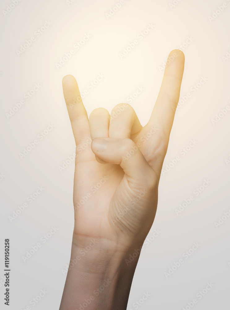 close up of woman hand showing rock sign close up of woman hand showing rock sign