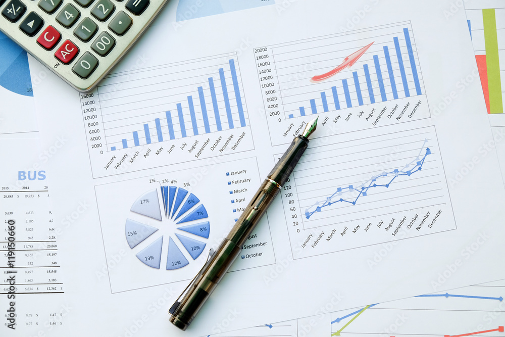 Desk office with pen, analysis report ,calculator. view from top. concept of business analysis, data analysis. Desk office with pen, analysis report ,calculator. view from top. concept of business analysis, data analysis.