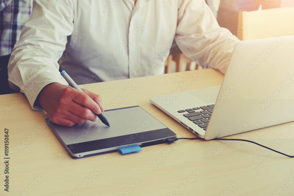 Graphic Designer using digital Drawing tablet and Pen on a computer Graphic Designer using digital Drawing tablet and Pen on a computer