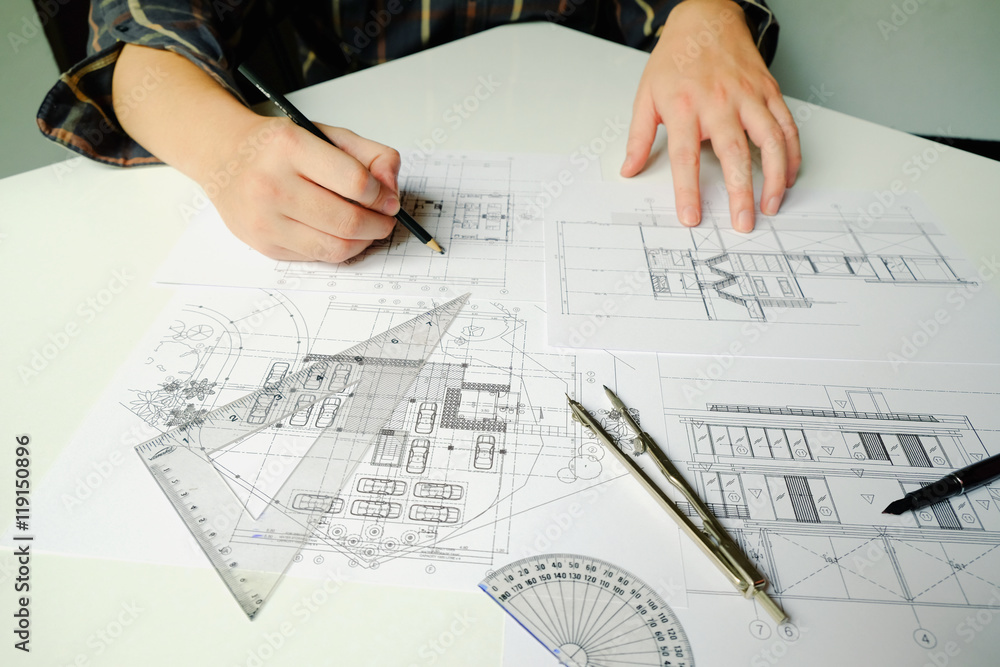 Close up man working of Architect sketching a construction project on his plane project at site construction work