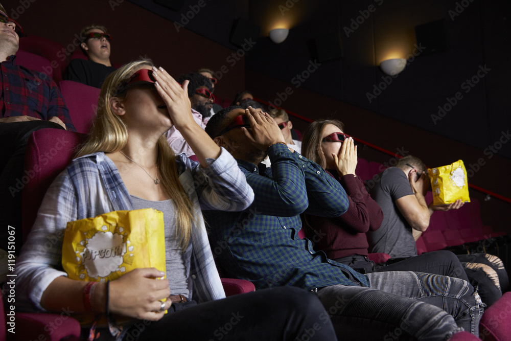Naklejka premium Couple In Cinema Wearing 3D Glasses Watching Horror Film