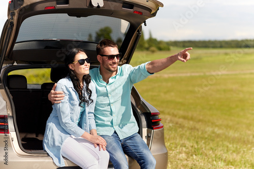 happy couple hugging at open hatchback car trunk © Syda Productions