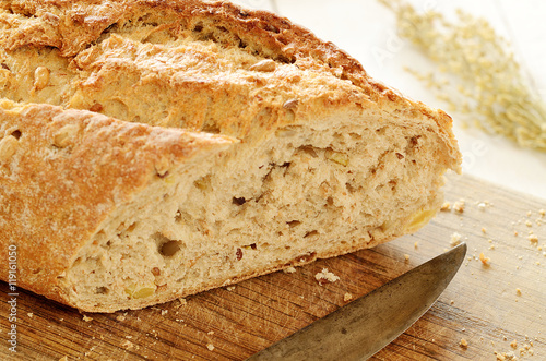 Close-up of fresh wheat bread on wooden cutting board