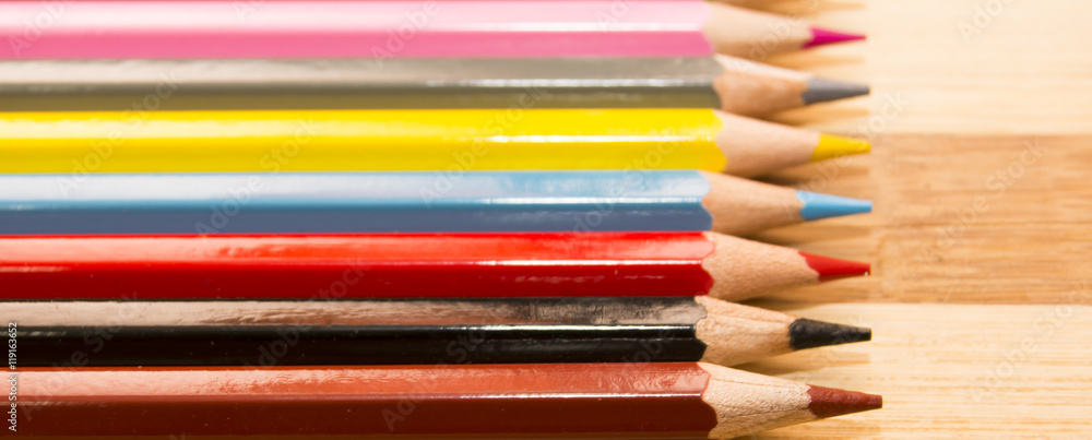 Fototapeta premium Colored pencils isolated on wooden background