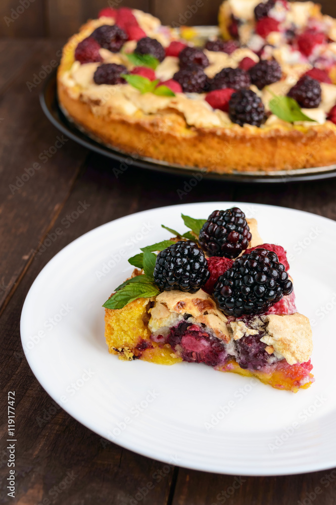 A piece of the pie (Tart) with fresh blackberries and raspberrie A piece of the pie (Tart) with fresh blackberries and raspberrie