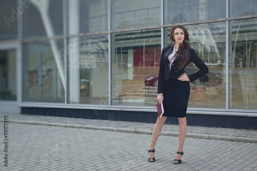 Attractive business woman in suit on a street