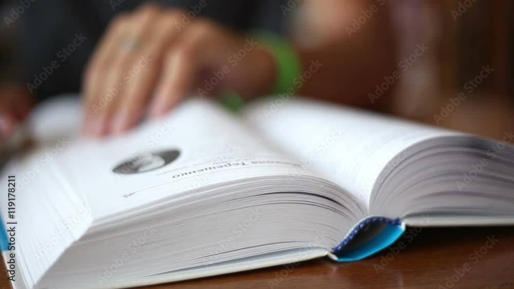 men finding information in a book in the library, close up