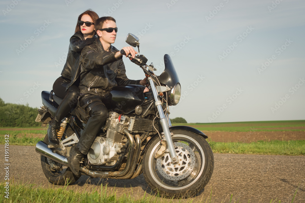 Active couple riding on the motorbike Active couple riding on the motorbike