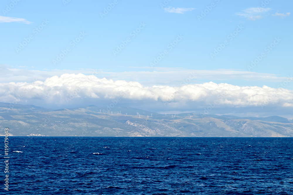 Sea background. Blue sea and clouds above