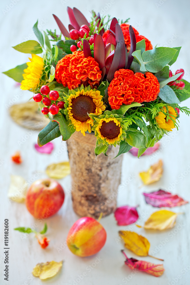 Obraz premium Autumn bouquet of flowers with apples and leaves . Autumn still life.