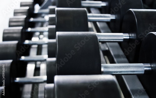 Dumbbells in the gym for classes bodybuilding for men, fitness and approach to iron weight.