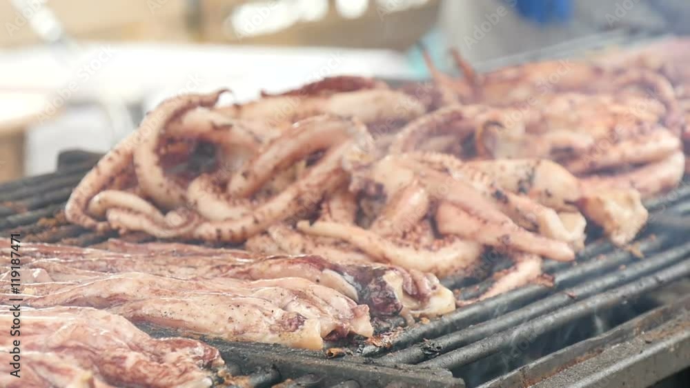 preparation of squids on the grill, close up , slow motion preparation of squids on the grill, close up , slow motion