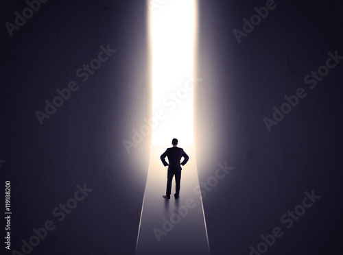 man looking at opened concrete wall