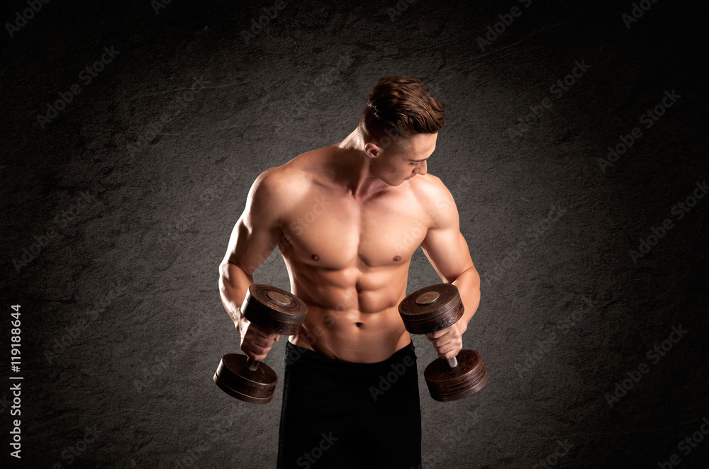 Fototapeta premium Sexy weight lifter guy showing muscles