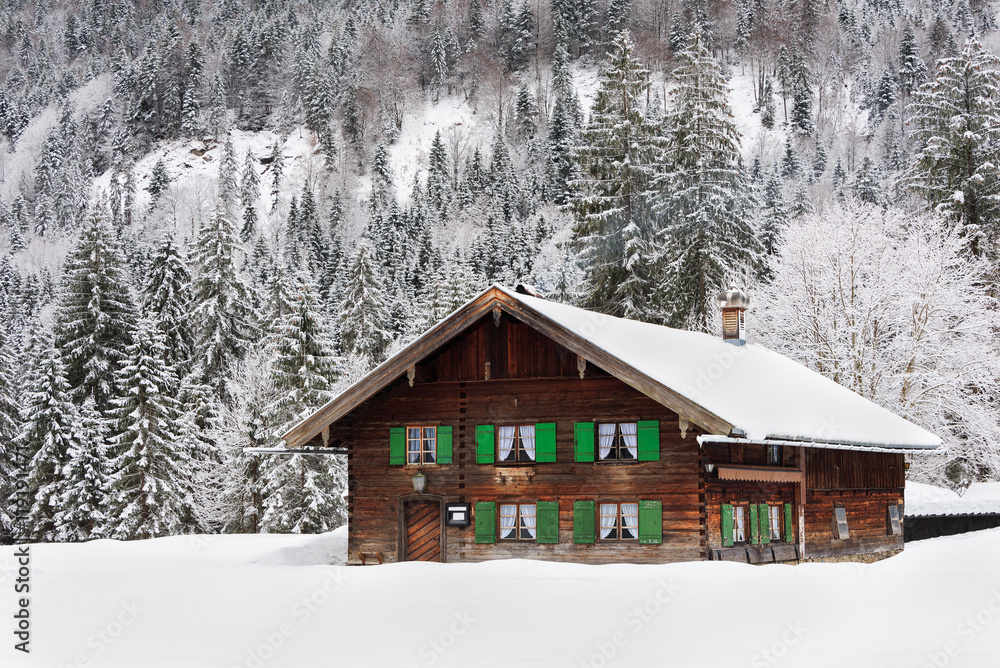 Wooden house in Bavaria in the snow