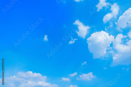 Blue sky with white clouds floating across the full sky.