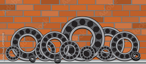 A series of bearings of different diameters on the brick wall