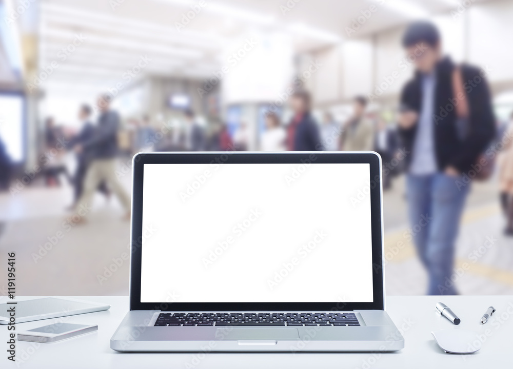 Laptop computer with blurred image of business people background Laptop computer with blurred image of business people background