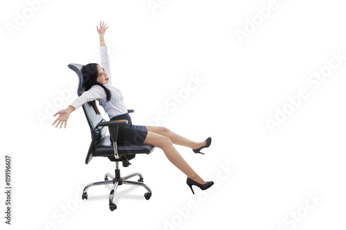 Happy female worker sits on office chair