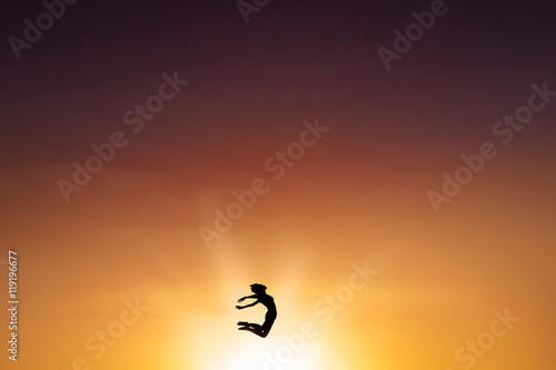 Happy woman jumping at dusk time