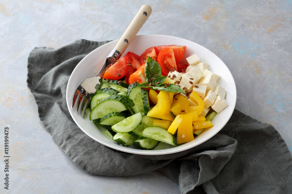 Tomatoes, cucumber and paprika salad in white bowl Tomatoes, cucumber and paprika salad in white bowl