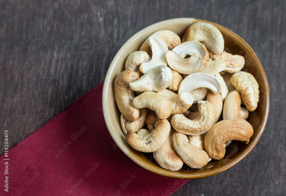 Bowl of cashew nuts from above. On wood background. Bowl of cashew nuts from above. On wood background.