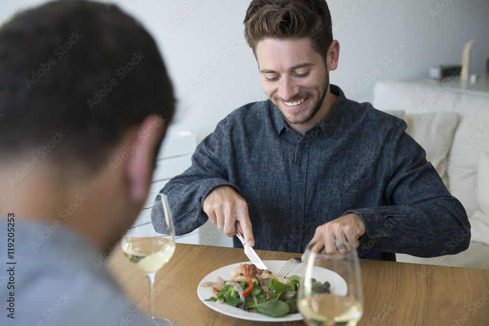 Gay Male Couple At Home Eating Meal Together Gay Male Couple At Home Eating Meal Together