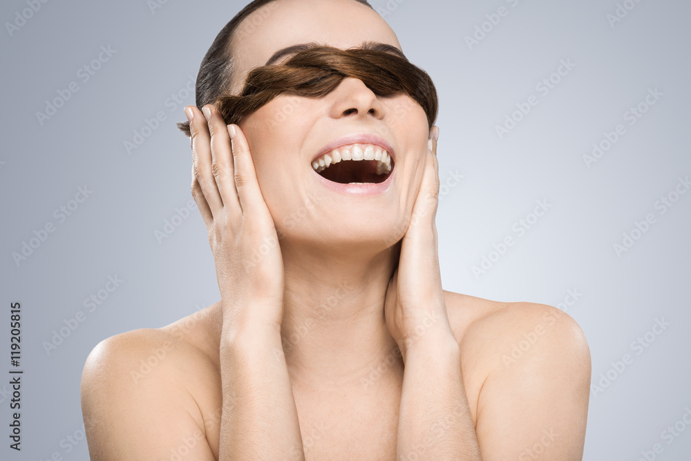 Model closing her eyes with pigtail and smiling Model closing her eyes with pigtail and smiling