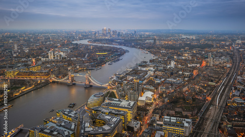 London, England - Aerial Skyline view of London with the iconic Tower Bridge, Tower of London and skyscrapers of Canary Wharf at dusk