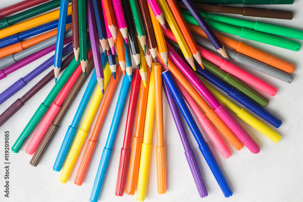 colored pencils and felt-tip pens on a white background colored pencils and felt-tip pens on a white background