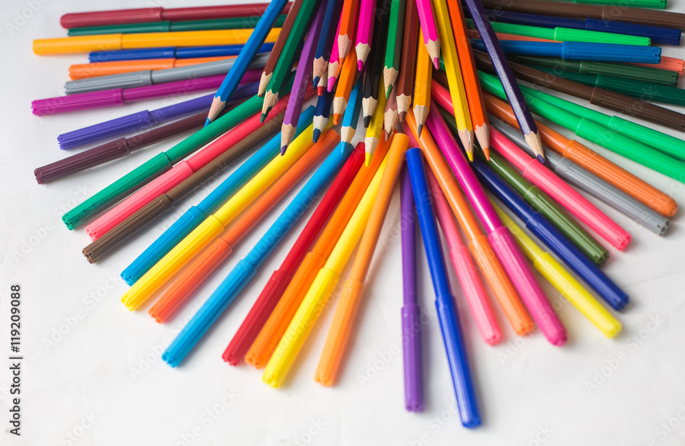 colored pencils and felt-tip pens on a white background colored pencils and felt-tip pens on a white background
