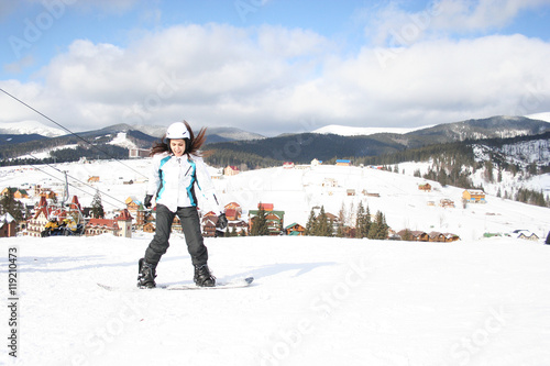 Young woman on snowboard in winter