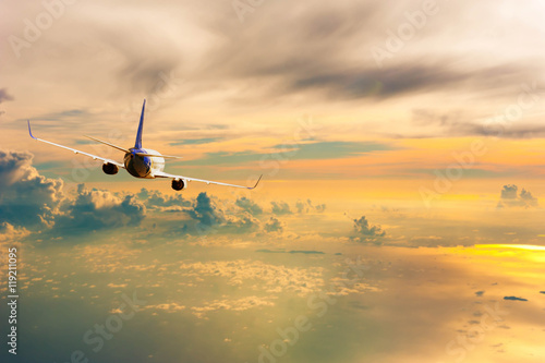 Airplane with background of cloudy sky at sunset or sunrise, exp