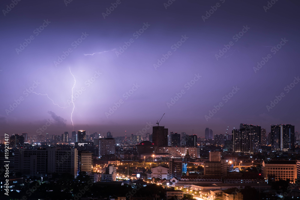 Lightning storm over city in purple light Lightning storm over city in purple light