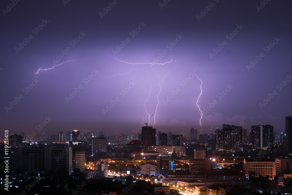 Fototapeta premium Lightning storm over city in purple light