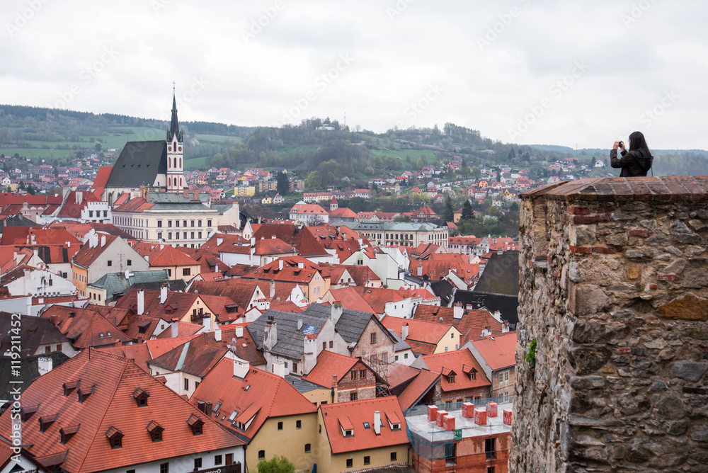 Tourist taking photo of Cesky Krumlov city view from roof top