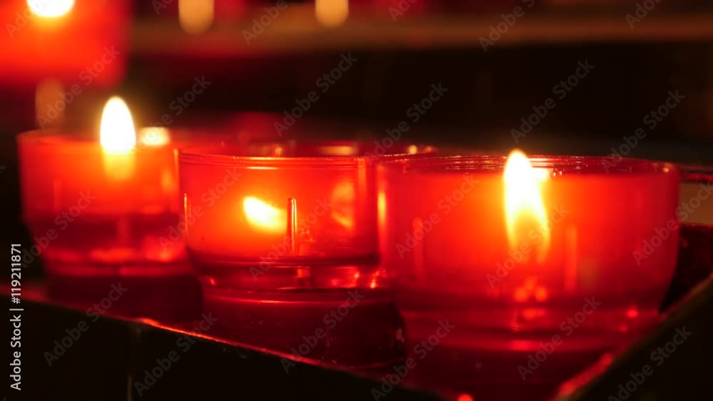 Lit of red of Christian catholic prayer votive candles in candle rack 4K 2160p 30fps UltraHD footage - Lot of red votive candles arranged in church 4K 3840X2160 UHD video Lit of red of Christian catholic prayer votive candles in candle rack 4K 2160p 30fps UltraHD footage - Lot of red votive candles arranged in church 4K 3840X2160 UHD video