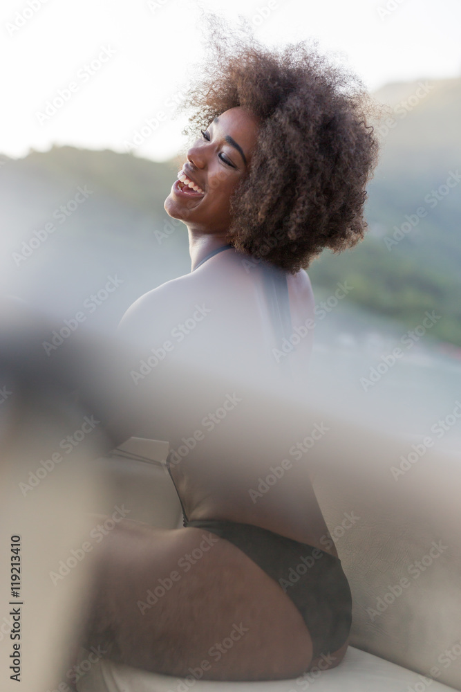 Beautiful and sexy young afro american woman posing in her bikin